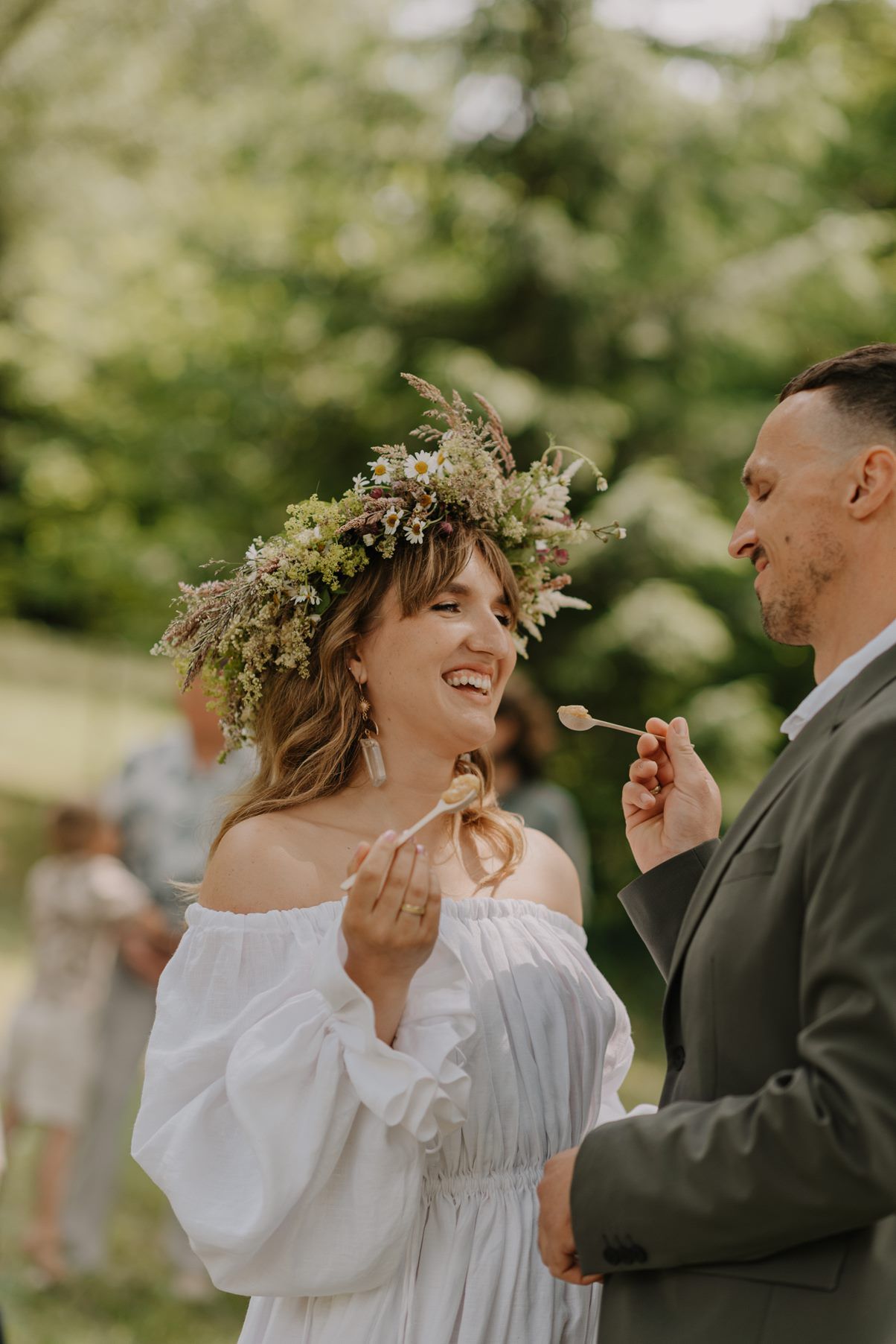 A joyful moment shared between newlyweds in a sunny garden setting.