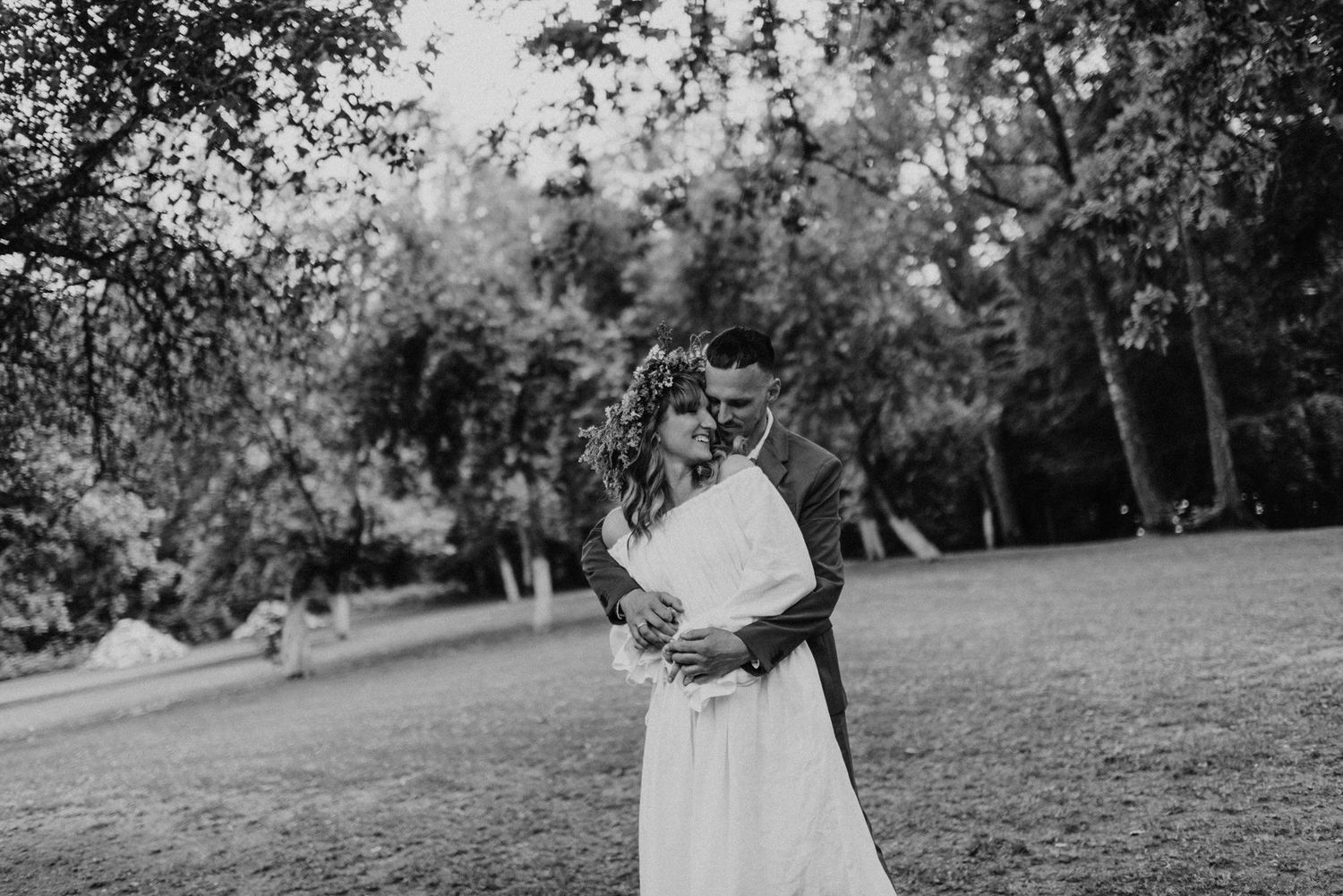 An outdoor celebration in a serene meadow setting with natural greenery and trees.