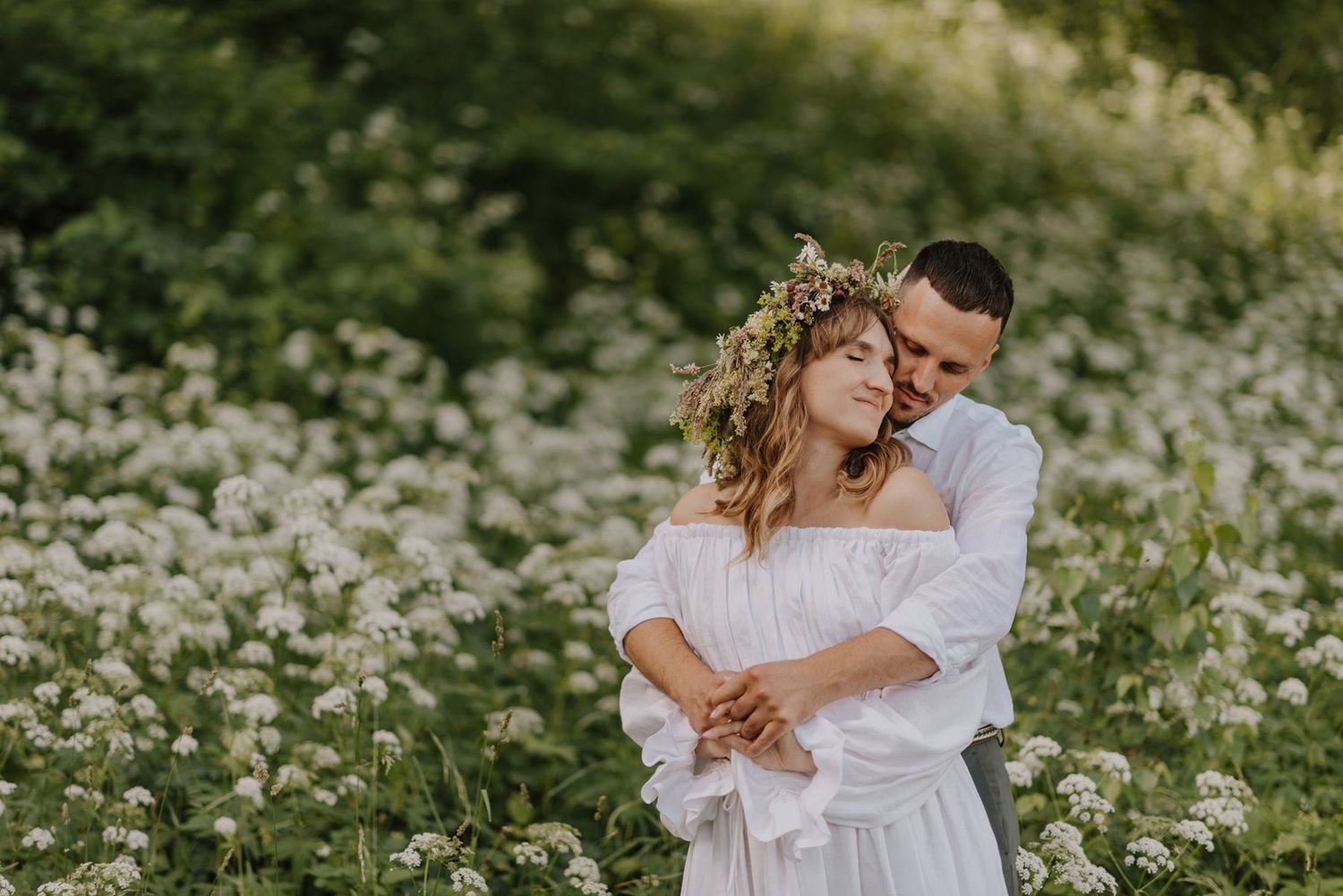 Romantic couple moment in a field of wildflowers on their wedding day.
