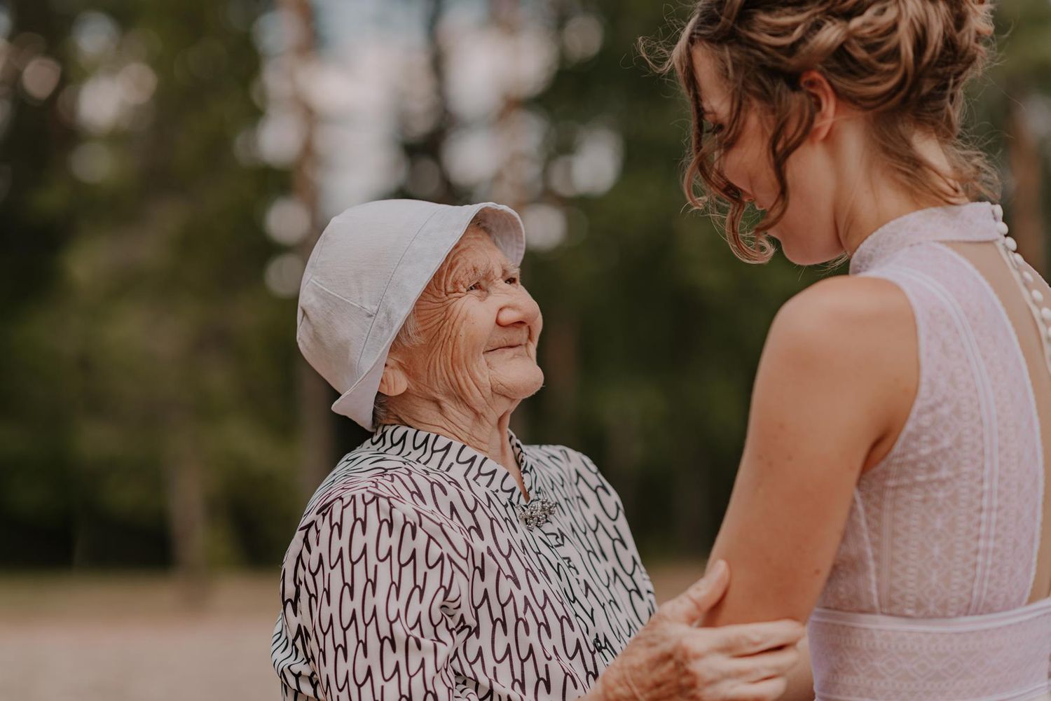 Candid emotional moment shared between guests at an outdoor celebration.