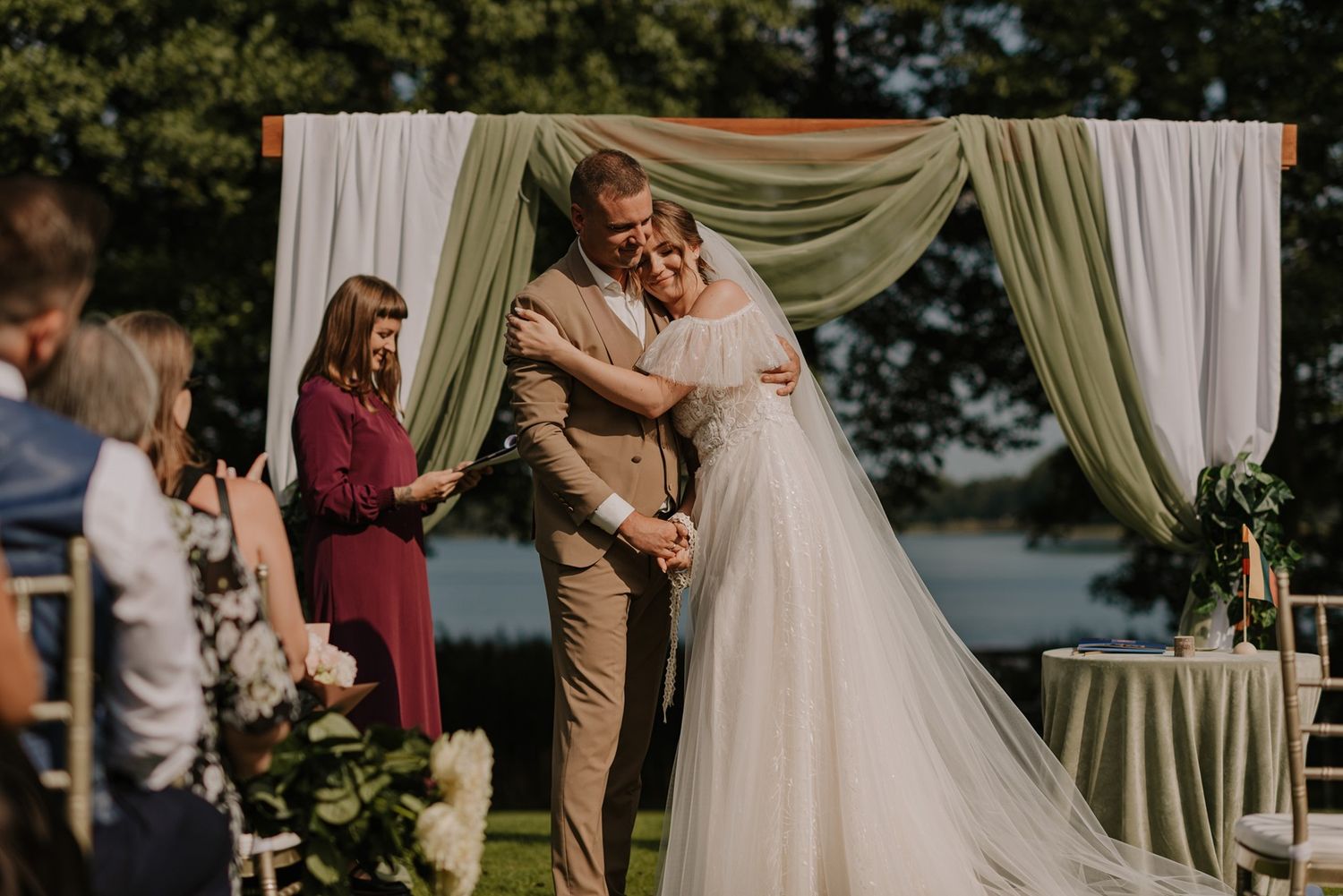 Wedding ceremony setup with elegant green draping and outdoor seating.