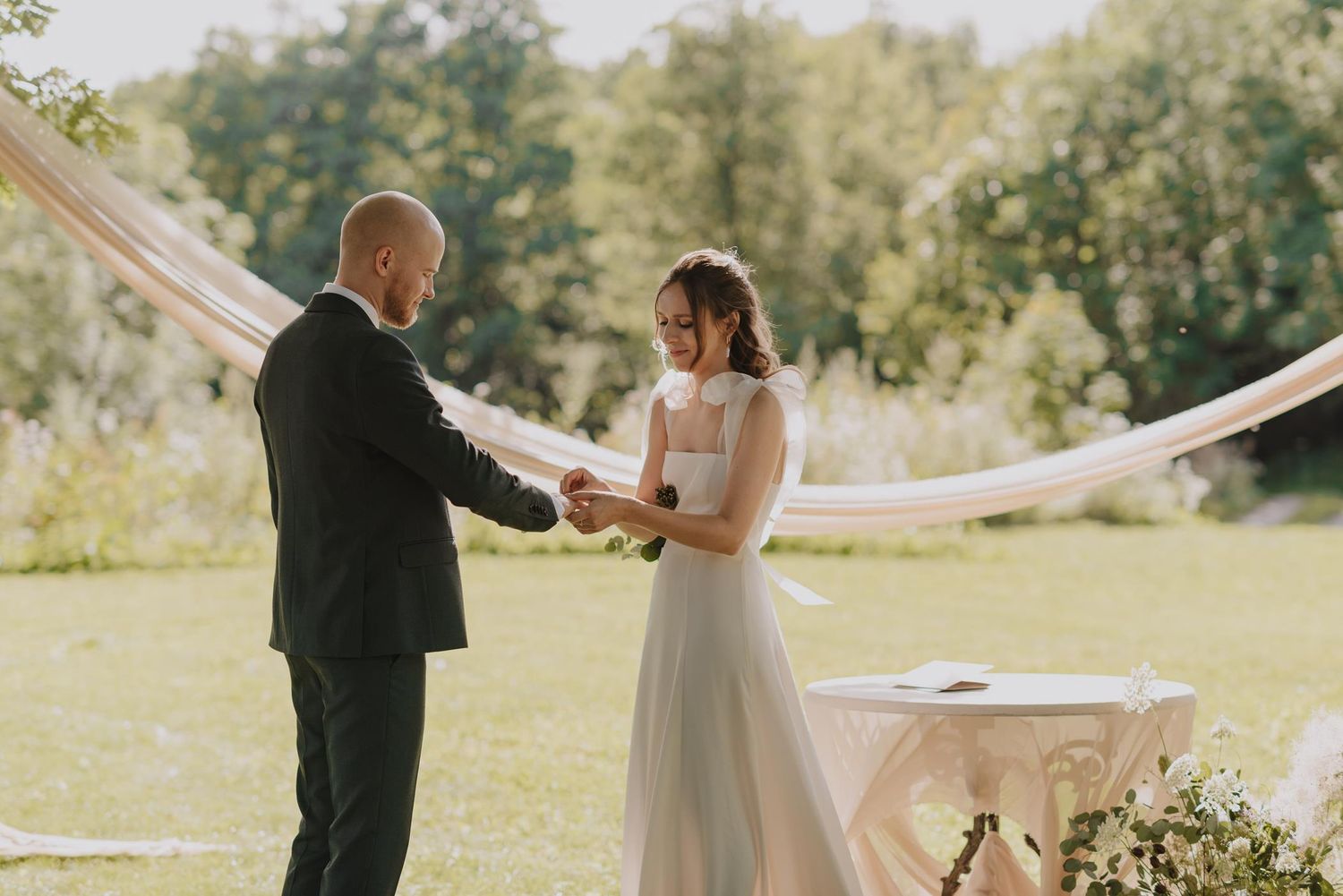 Couple exchanging vows during an outdoor garden wedding ceremony.