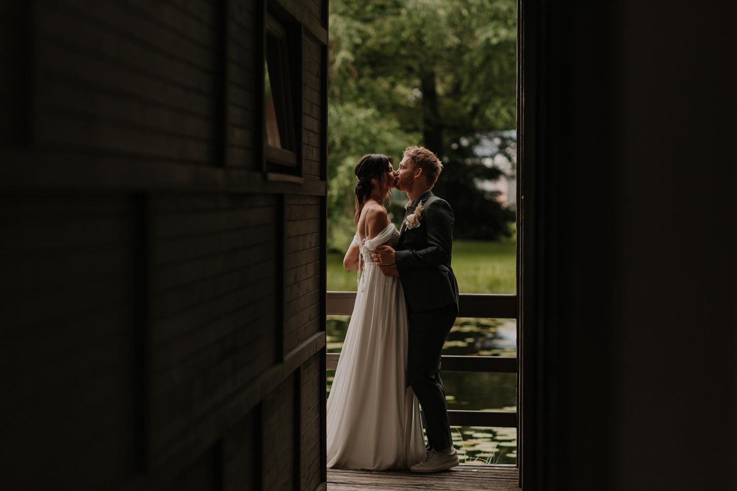 Wedding ceremony space with rustic wooden backdrop and natural greenery.