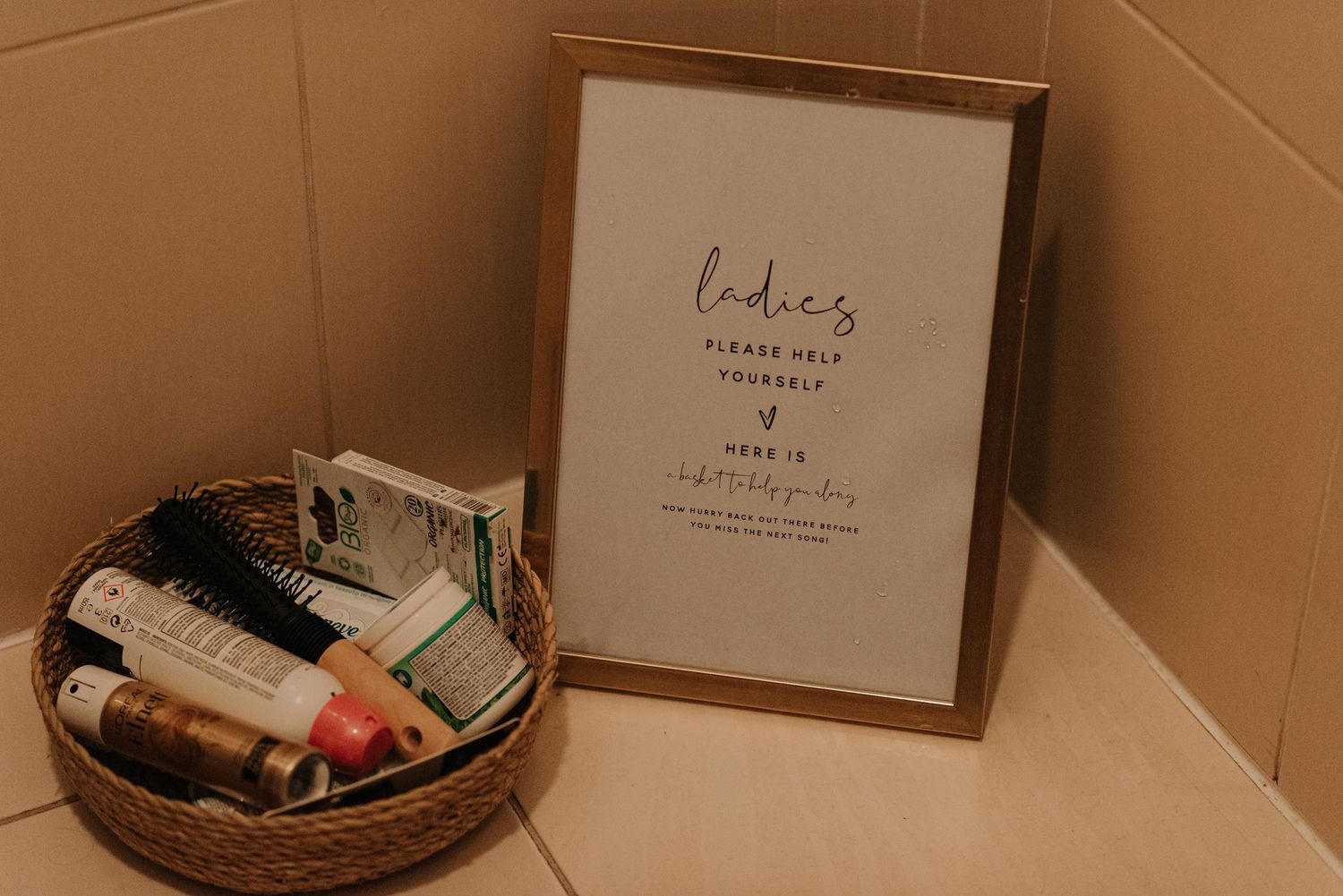 Simple wedding decor and signage displayed on neutral background.