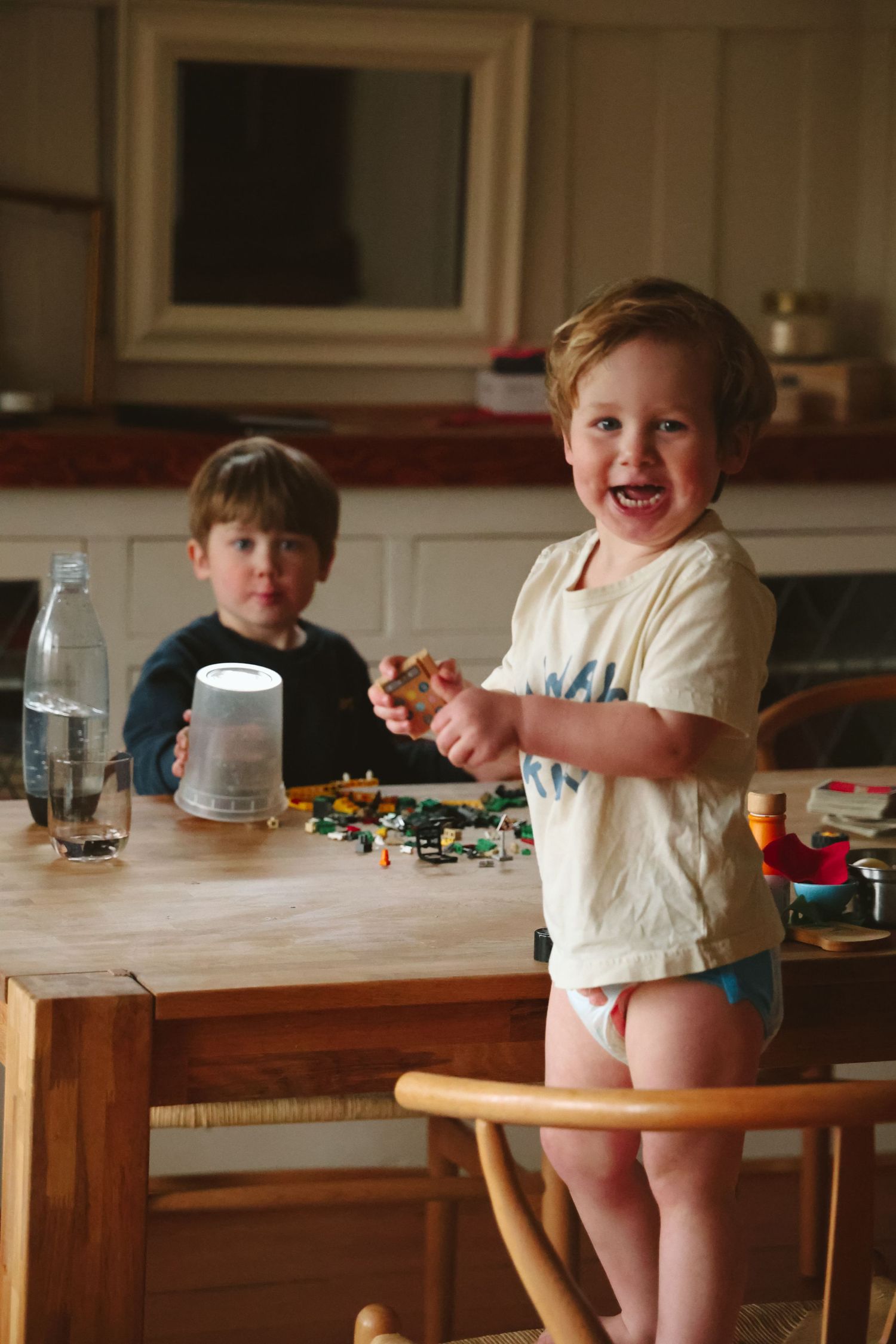 At-home playful photoshoot with two toddlers playing lego.