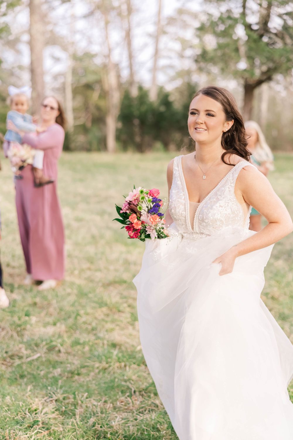 A joyful moment captured during an outdoor wedding with spring blooms and natural setting.