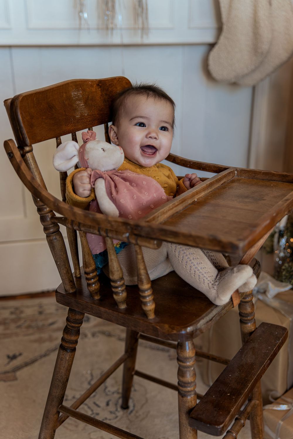 A vintage wooden high chair photographed from multiple angles showing its rustic details and worn patina.