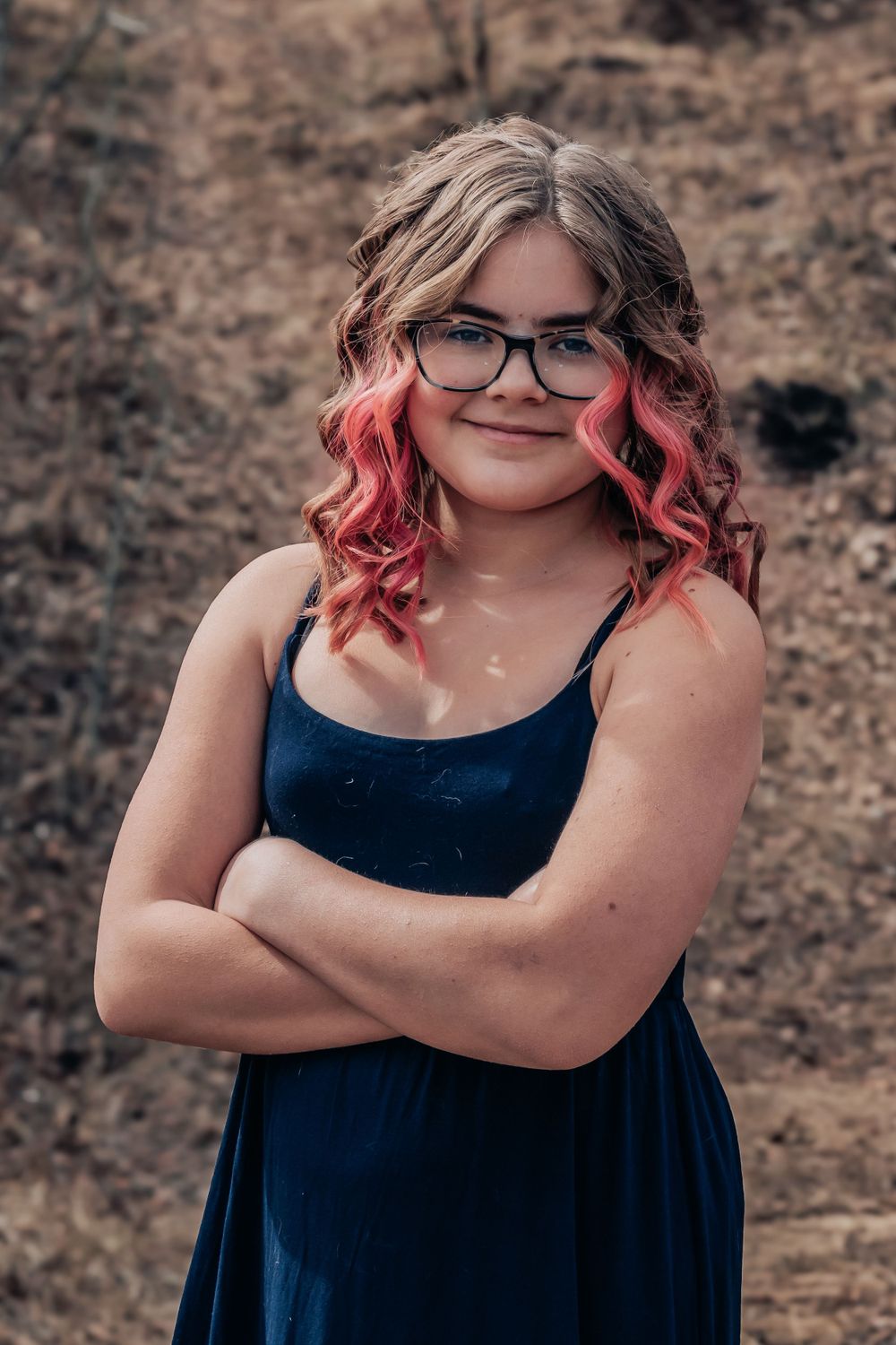 Portrait series showing person with pink-tipped hair and glasses posing confidently.