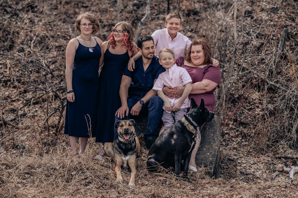 Group photo session capturing casual moments outdoors against natural backdrop.