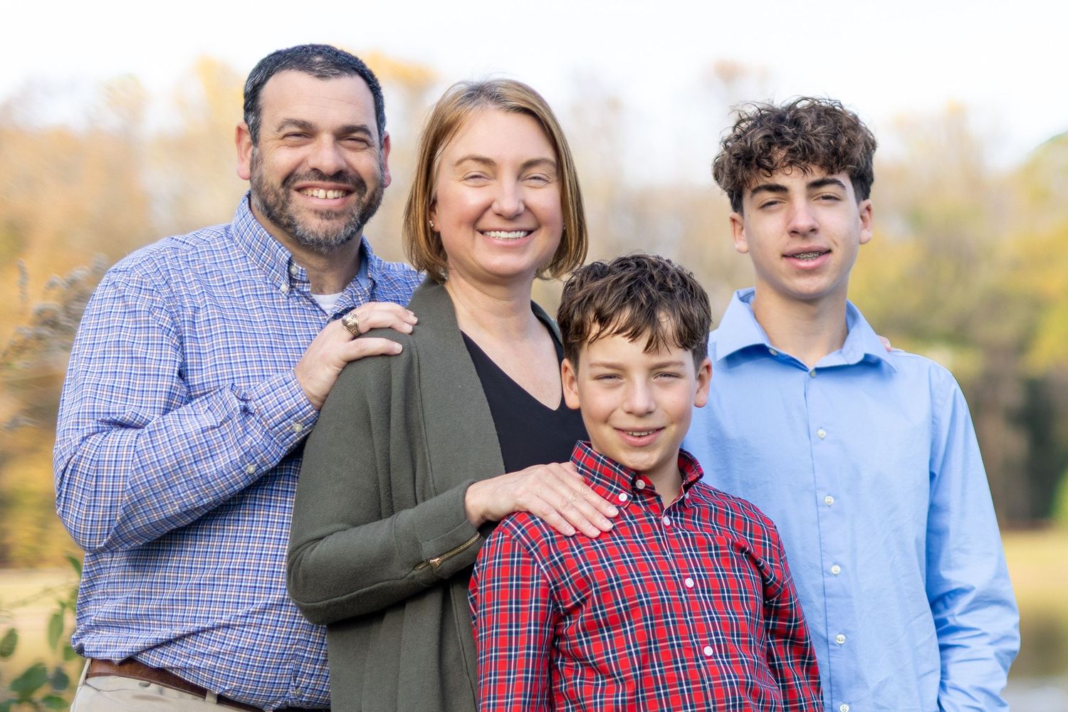 Outdoor family portrait in Amherstburg park during golden hour, photographed by a Windsor-based professional, Tasha Cannaday