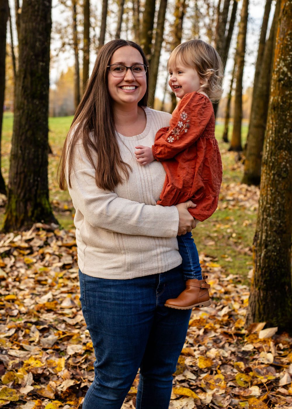 Candid moment of joy captured in autumn forest setting.