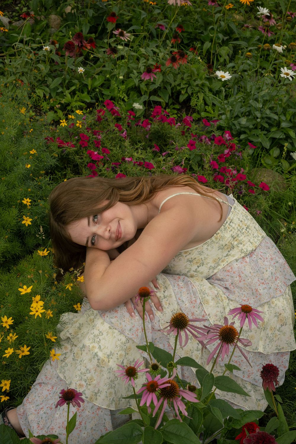 A dreamy portrait series among purple coneflowers and wildflowers in a garden setting during a senior portrait session in Remus, Michigan.