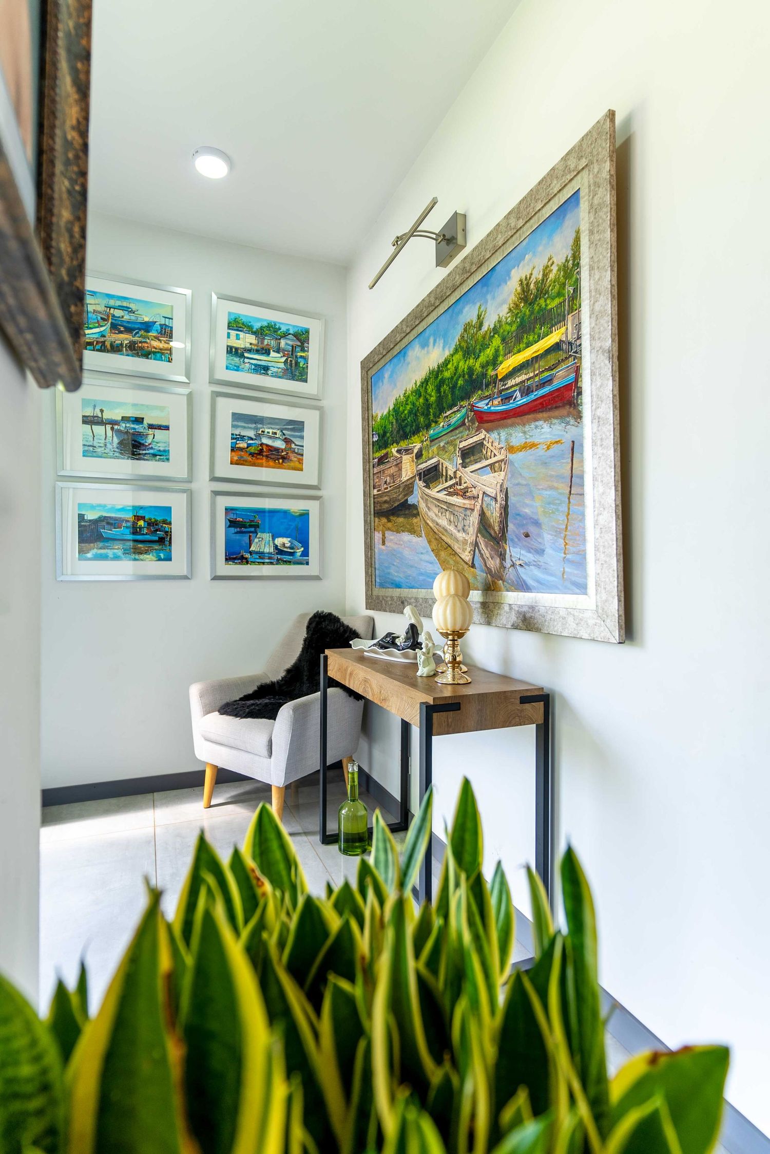Bright hallway with indoor plants and framed artwork, enhancing natural lighting