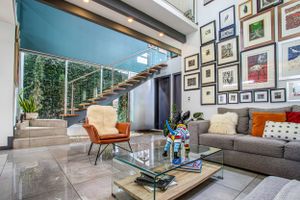 Elegant open-concept living area with floor-to-ceiling windows and artistic decor.