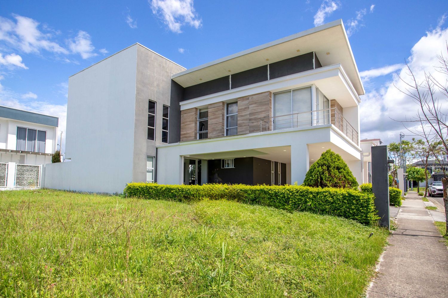 Elegant exterior of a contemporary luxury home with a spacious front yard