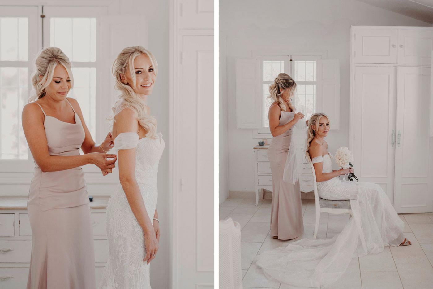 Two people share a sweet pre-wedding moment in an elegant white room with matching light-colored dresses.