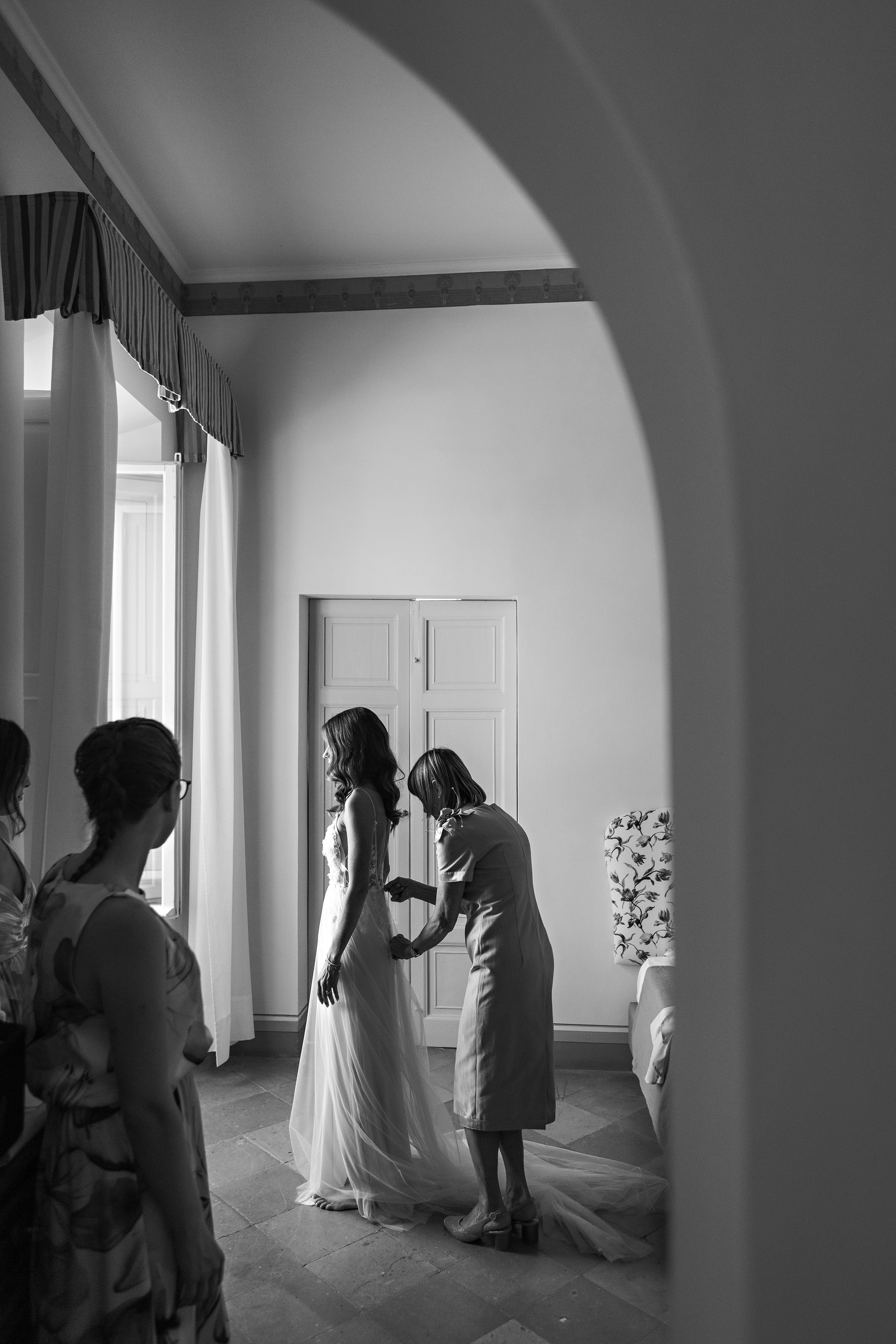 bride getting into wedding dress