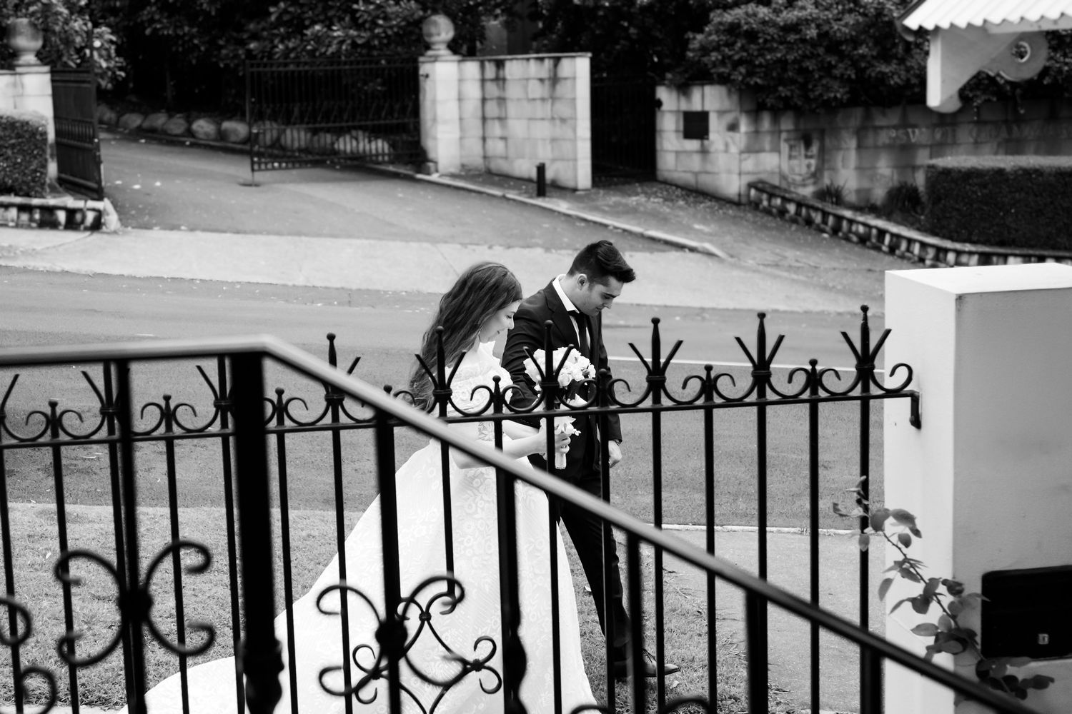 By_JoJo_Black_and_White_Wedding_Photography_Bride_&_groom_holding_hands_walking_down_stairs_at_Anzac_Square_Brisbane_CBD_www.byjojo.com.au
