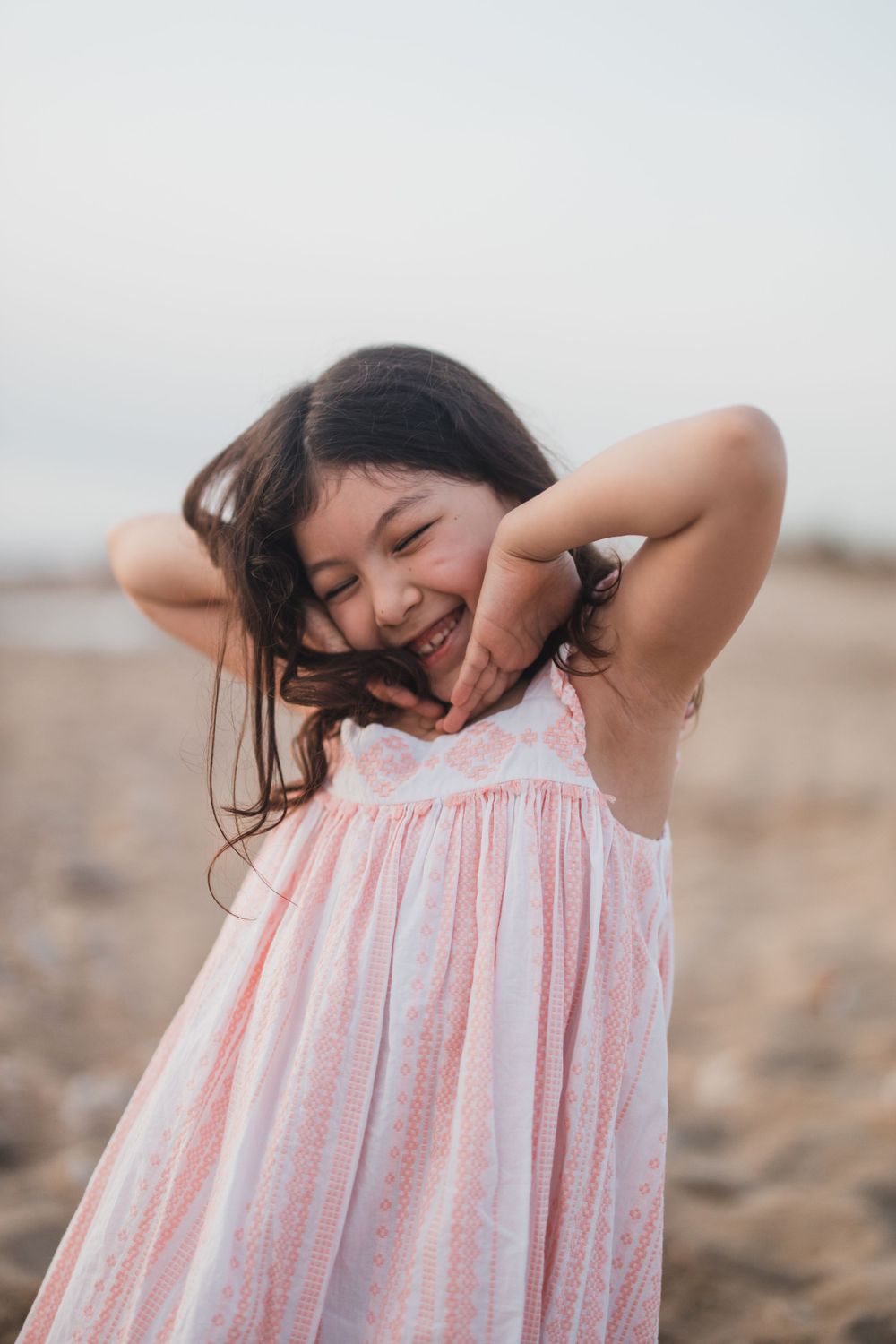 A playful moment captures someone in a pink dress making silly faces.
