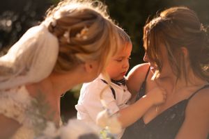 An intimate moment shared between people during an outdoor wedding ceremony.