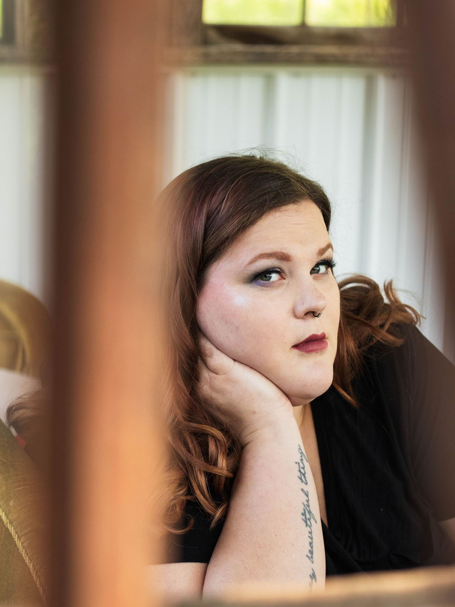 Artistic portrait through window reflection showing vintage interior decor.