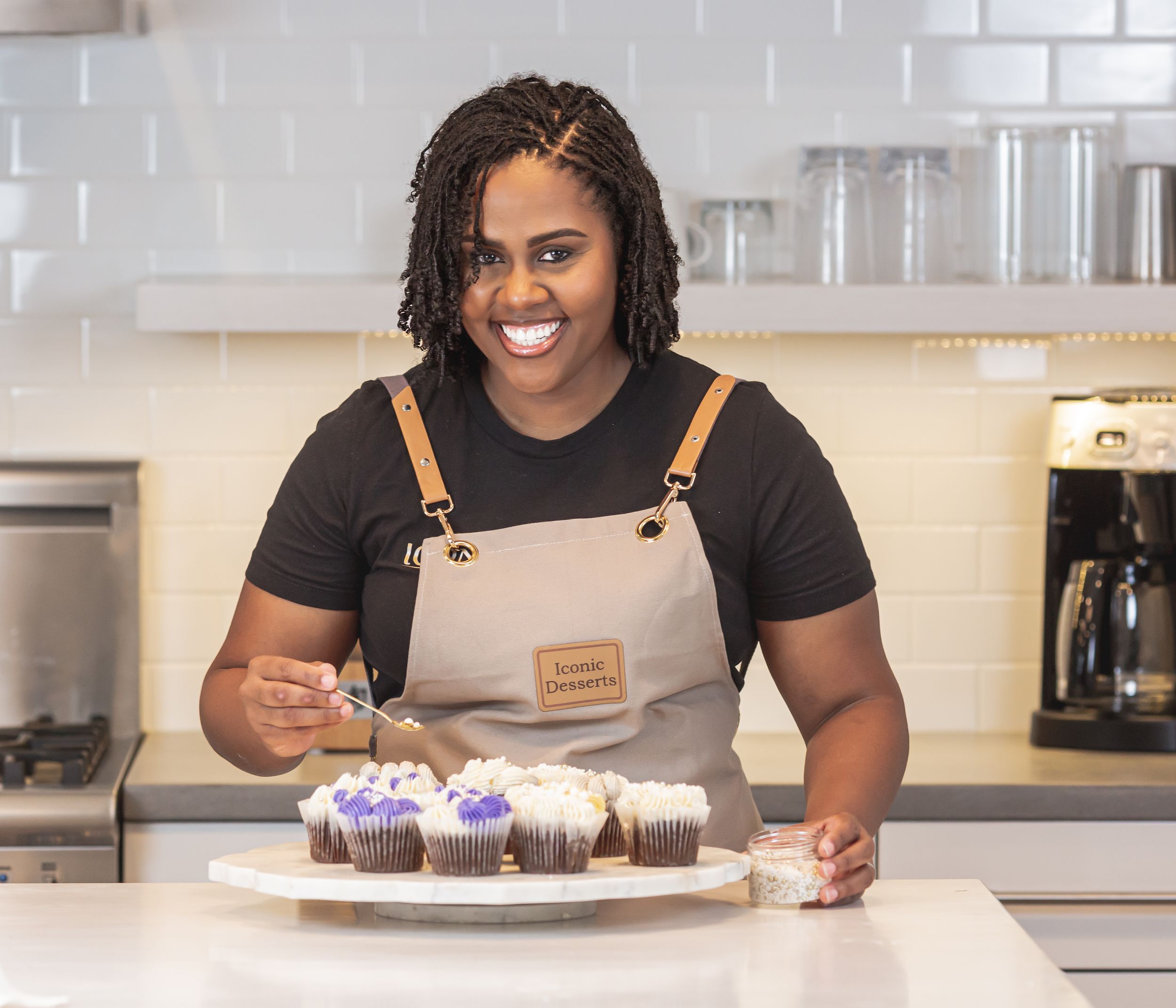 Woman celebrating a special occasion with a cake in a bright indoor setting.
