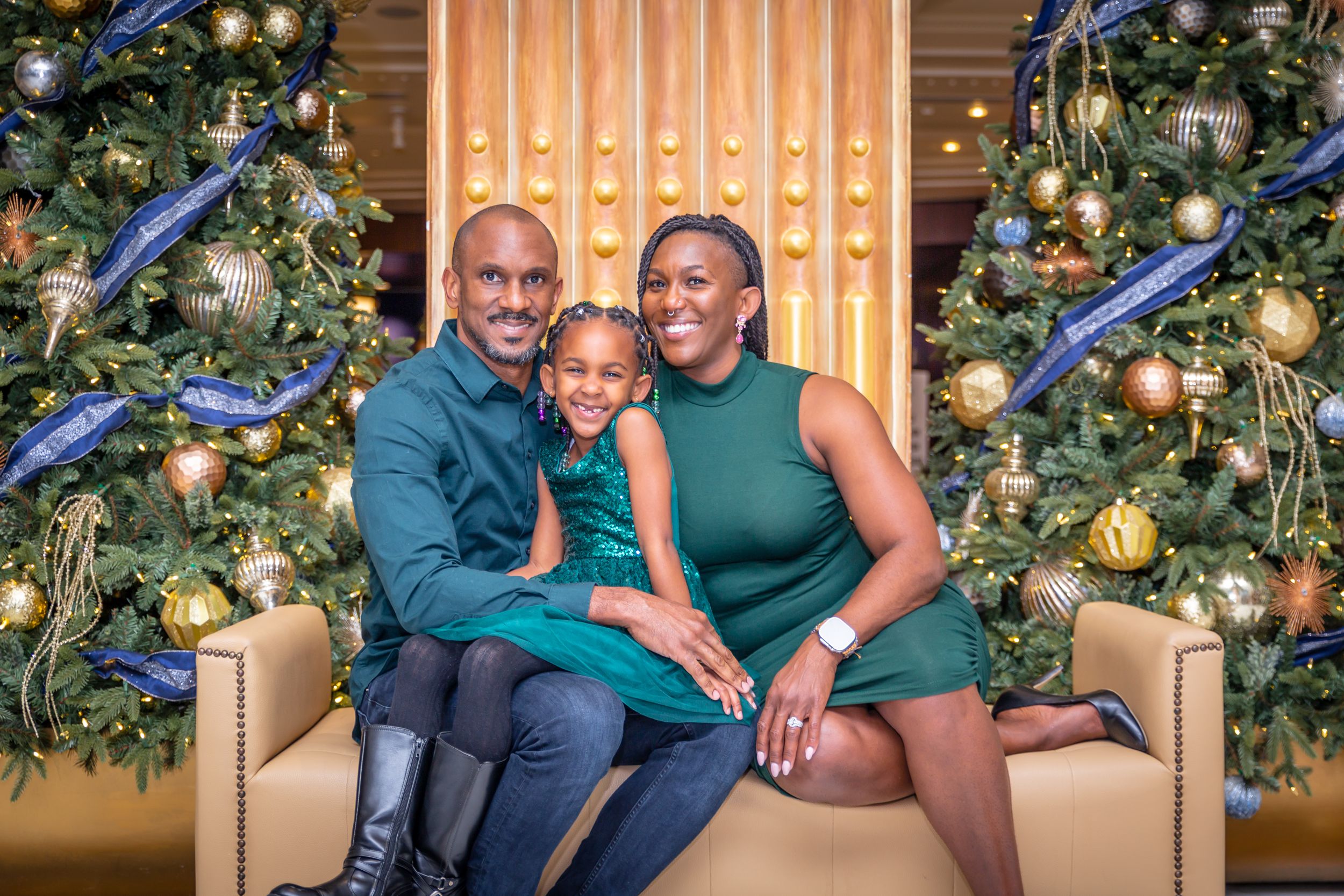 Couple posing together in green outfits at a Christmas themed photo session.