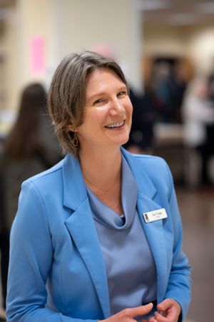 Portrait of woman smiling in light blue blazer.