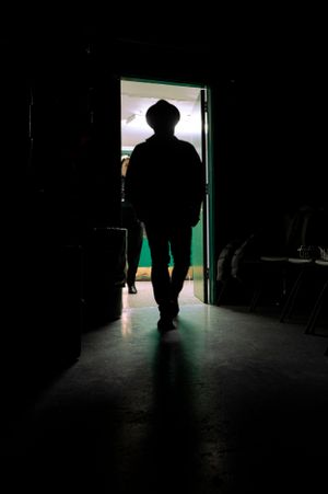 Silhouette of man walking through door prior to arriving on stage.
