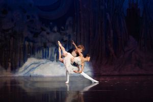 Nutcracker prince holding princess in swooping pose.