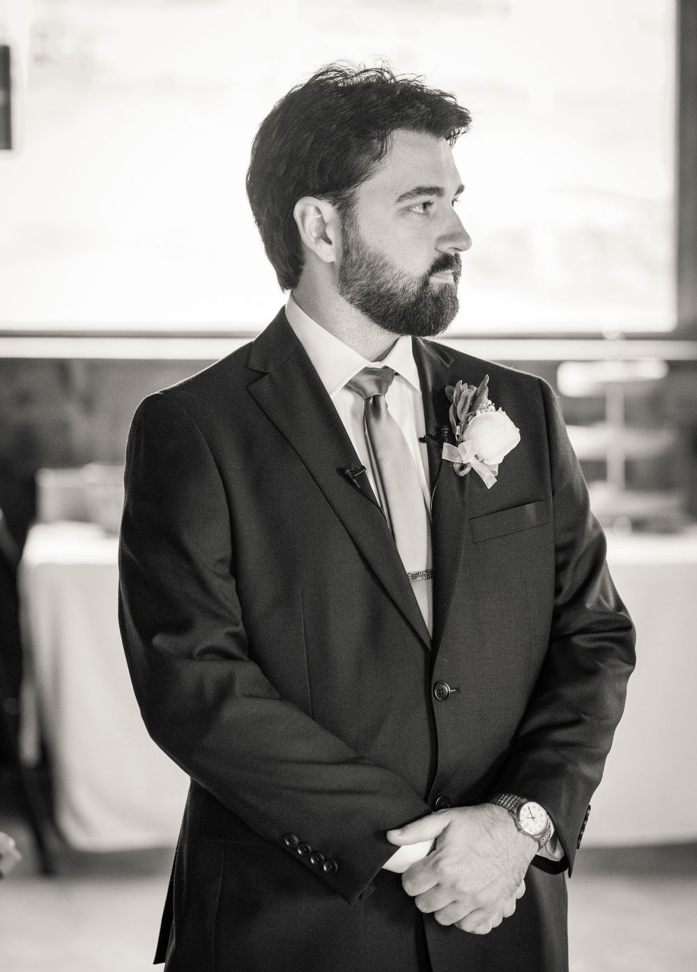 Close-up black and white detail shots of groom's formal attire and accessories.