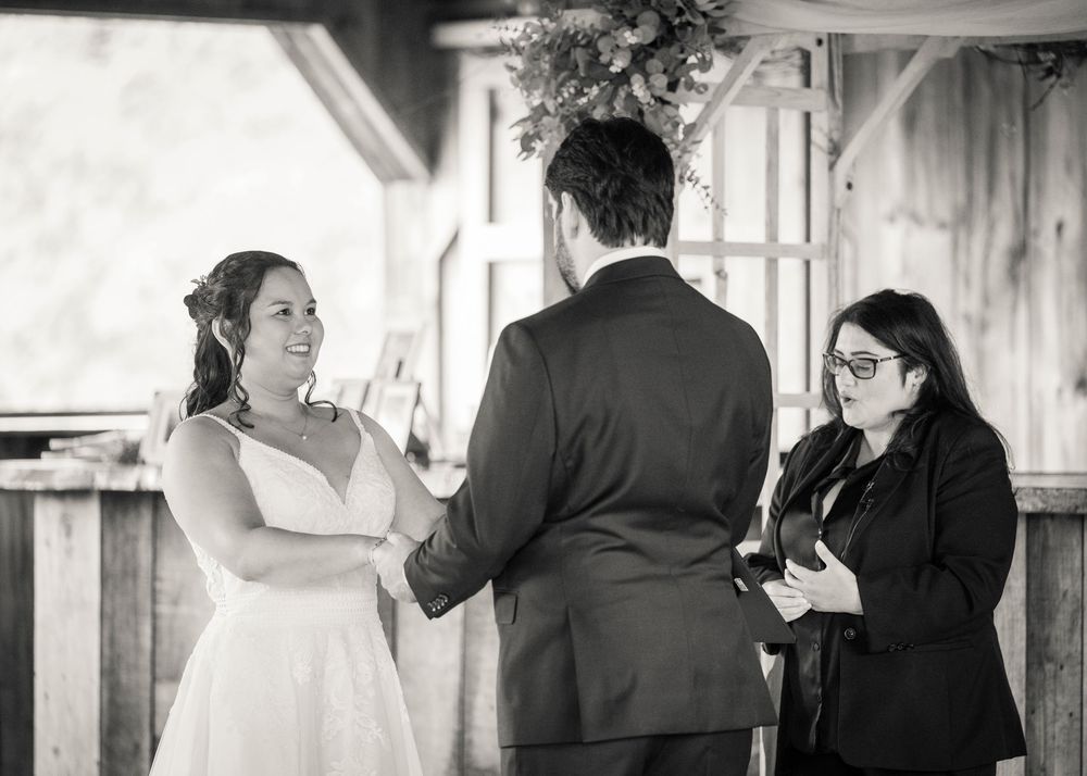 People conversing in a black and white hallway during what appears to be a special occasion or event.