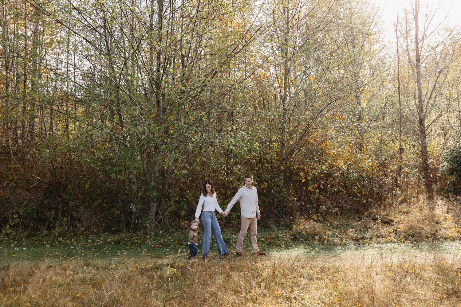 A black and white montage of candid family moments in a natural outdoor setting.