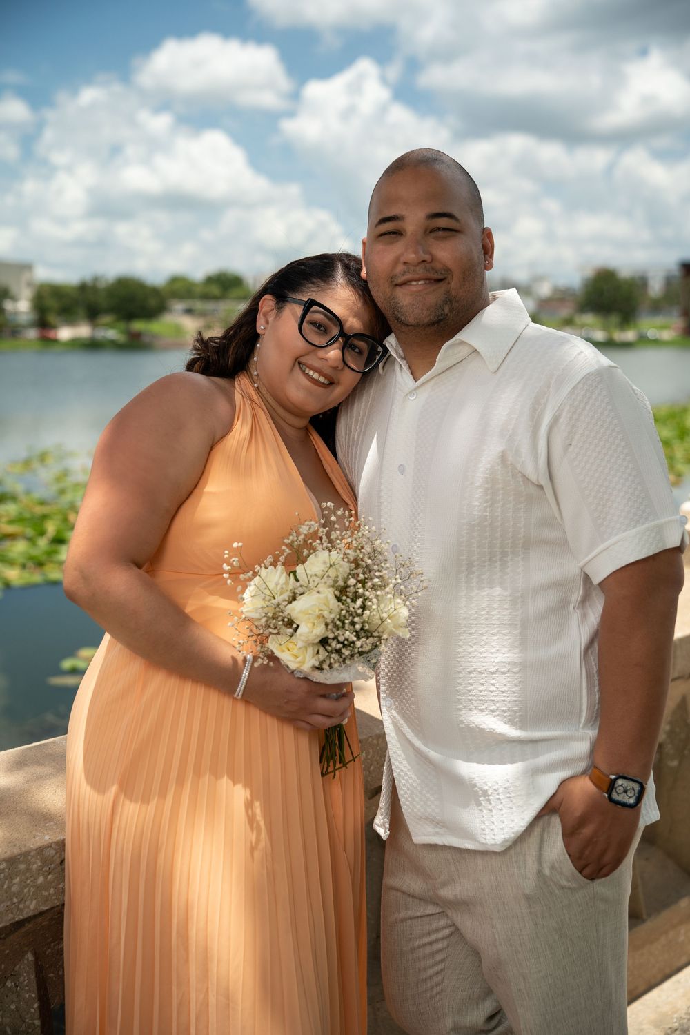 Engagement couple posing together on a waterfront overlook in Tampa, Florida — romantic golden hour photoshoot.