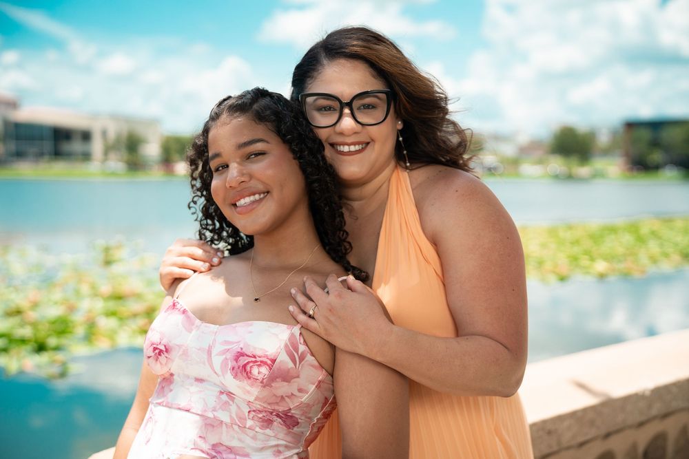 Smiling friends by the lake in Tampa, Florida, enjoying a sunny day photo session.