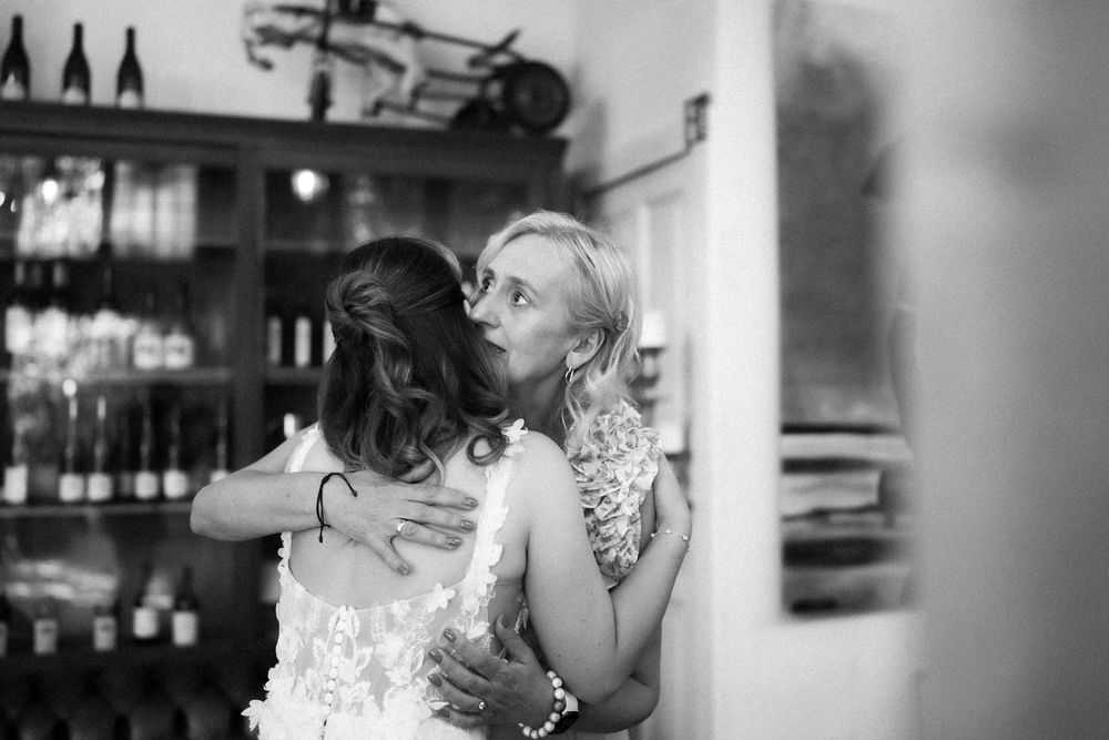 Black and white intimate wedding moment captured in soft focus.