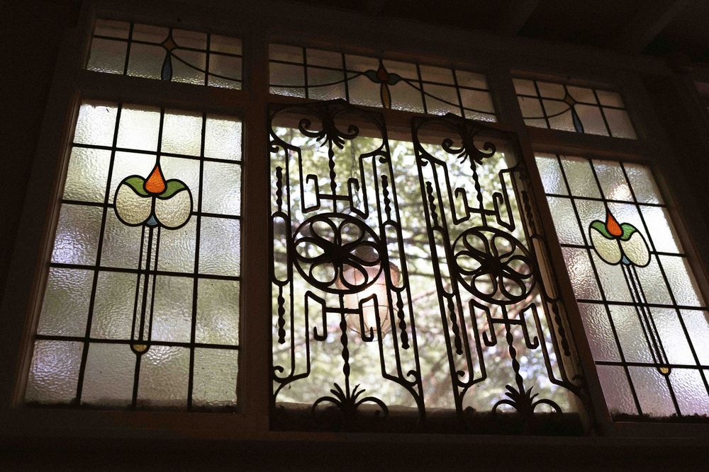 Ornate stained glass window panels with art deco design elements and colored circular accents.