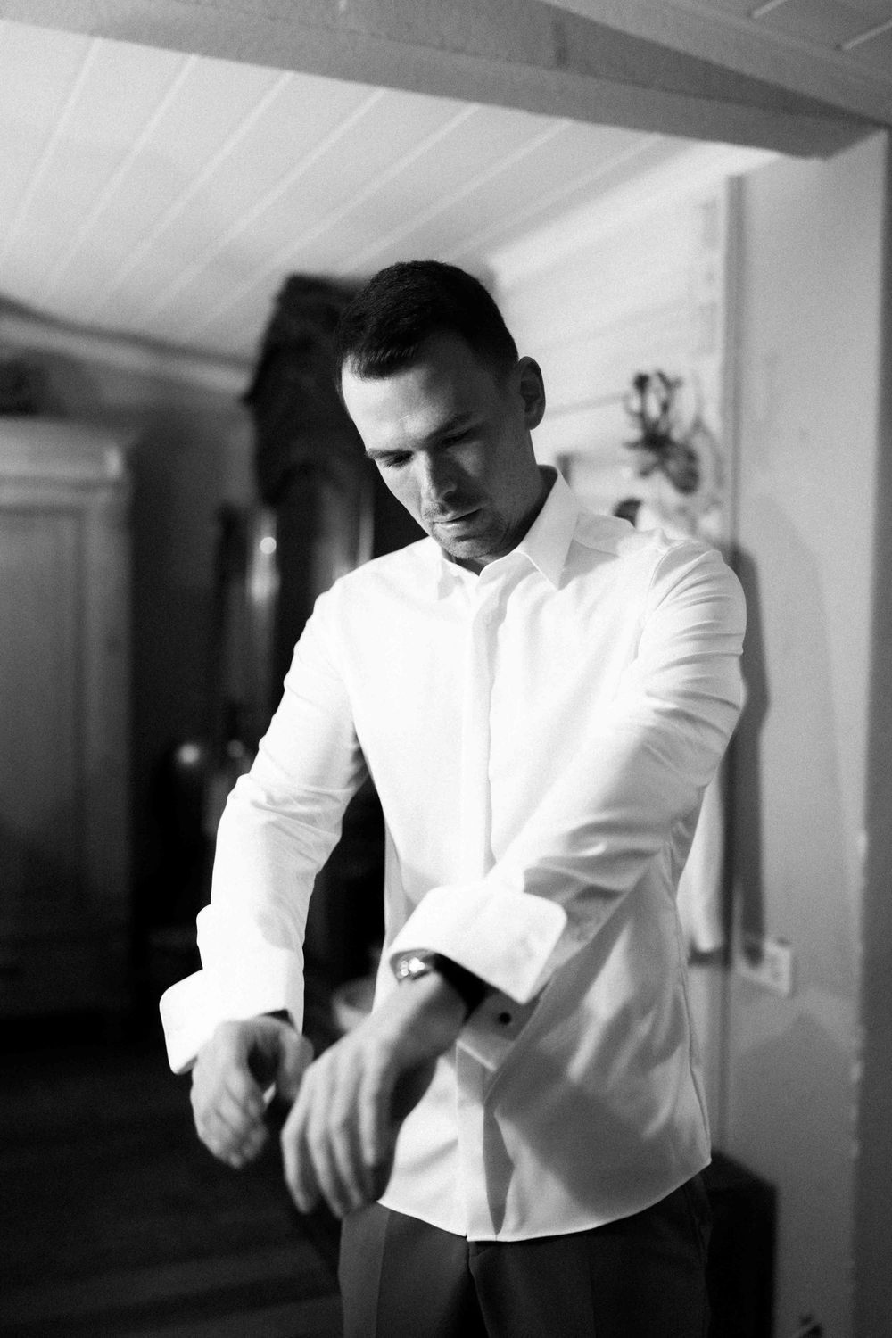 Black and white photo of formal preparation before a wedding ceremony.
