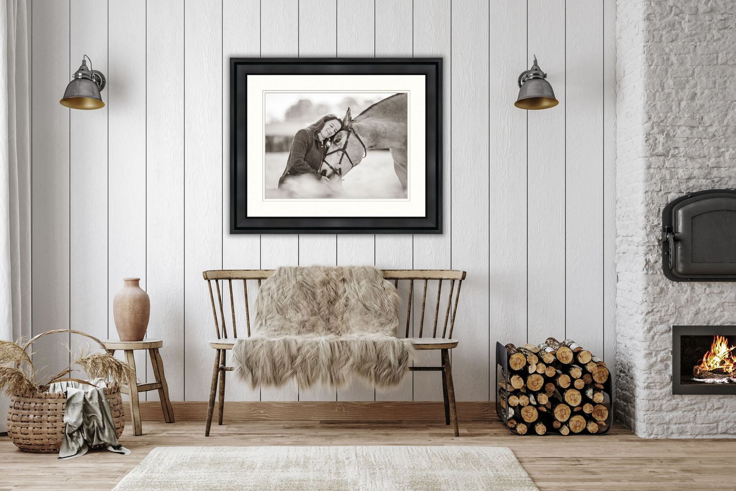 Rustic farmhouse living room with white shiplap walls, antique bench, framed artwork, and stone fireplace with stacked wood.