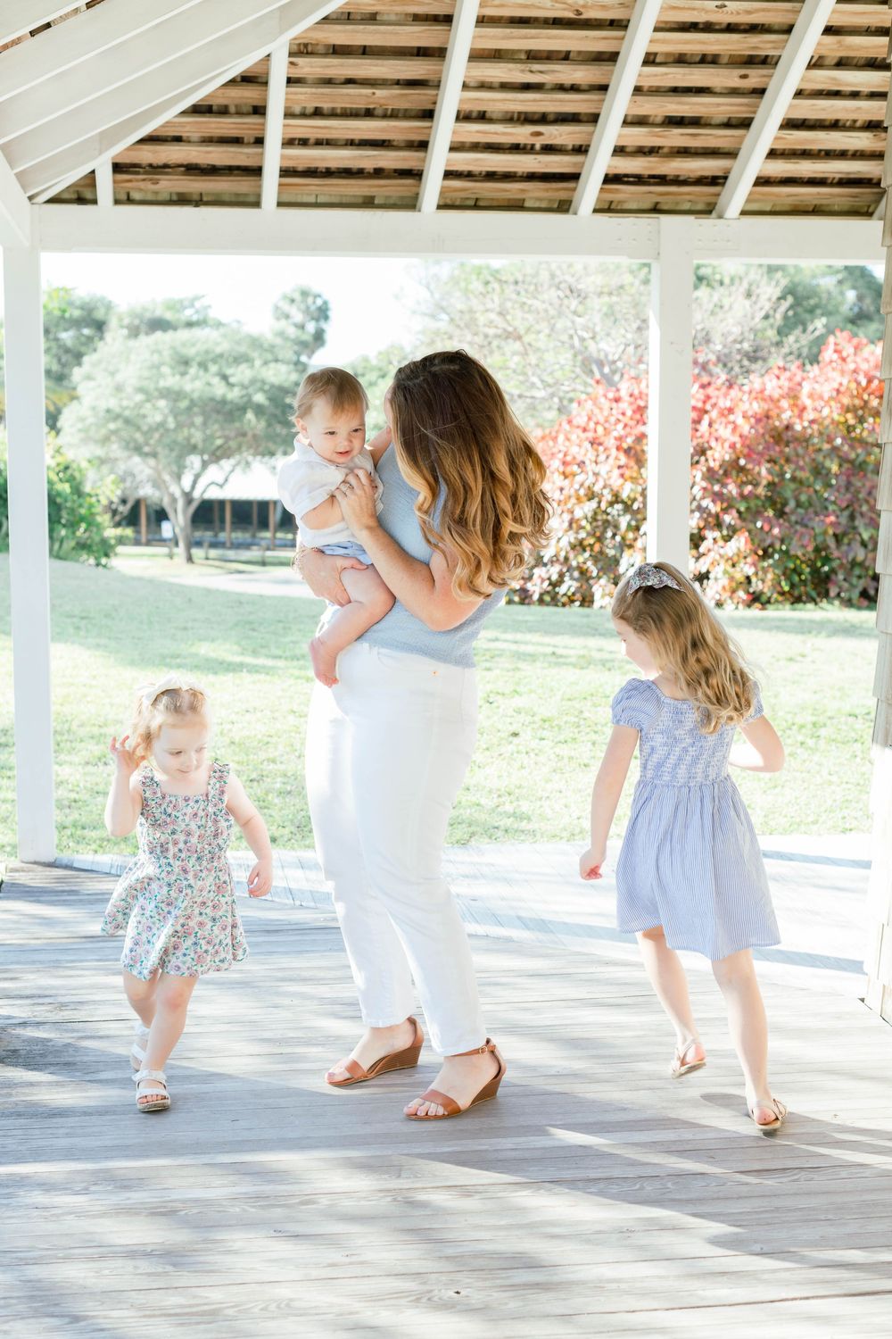 A tender moment of dancing and playing together on a bright gazebo on a sunny spring day.