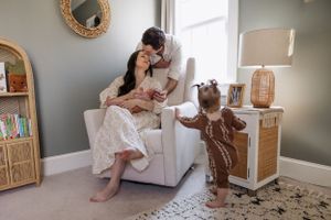 Mother and toddler share an intimate bonding moment in a cozy nursery with neutral decor and natural lighting.