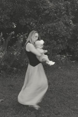 A series of motion photos shows someone in a flowing dress twirling and dancing in a garden setting.