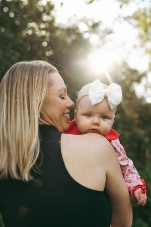 A tender moment between parent and child captured in a series of candid outdoor portraits at sunset.