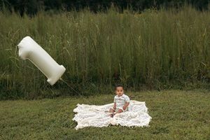 A sequence of photos showing a large plastic container falling and spilling white liquid onto grass.