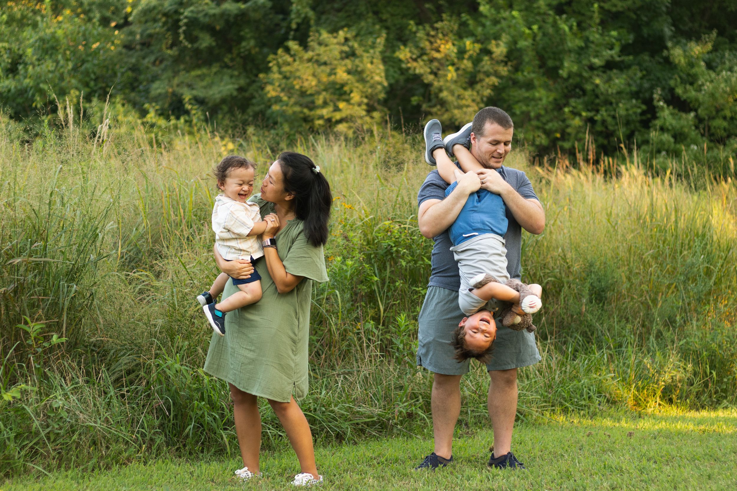 Families enjoying a sunny day outdoors in a grassy field.