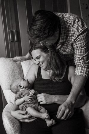 Black and white photo series showing affectionate moments between parent and infant.