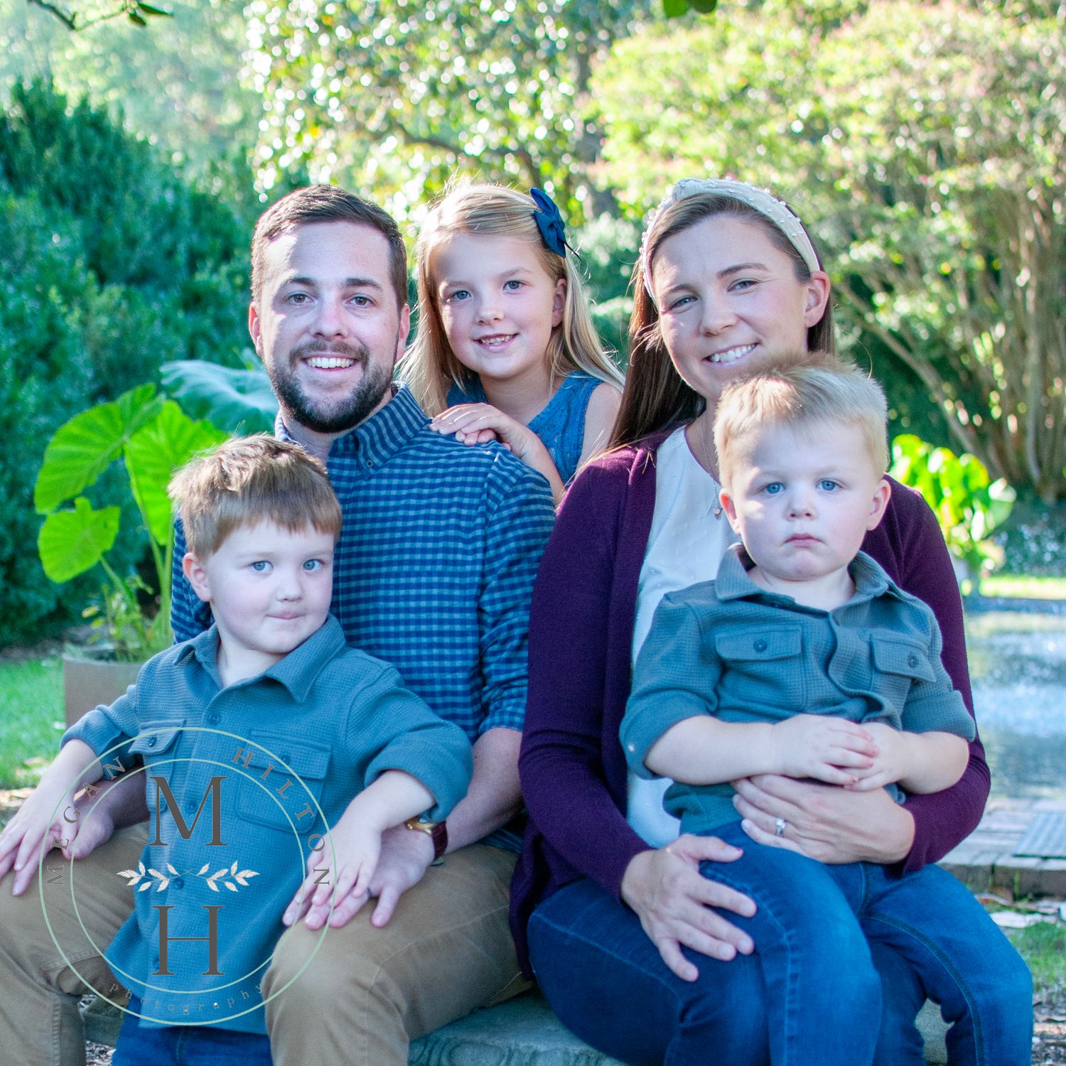 family sitting near reflecting pool at Morven Park