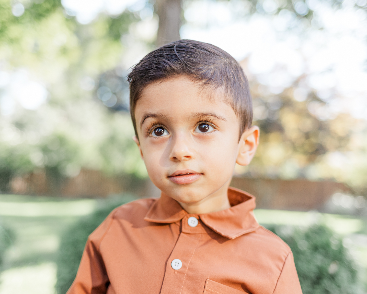 little boy smiling in burnt orange shirt during Hudson valley fall family photo session