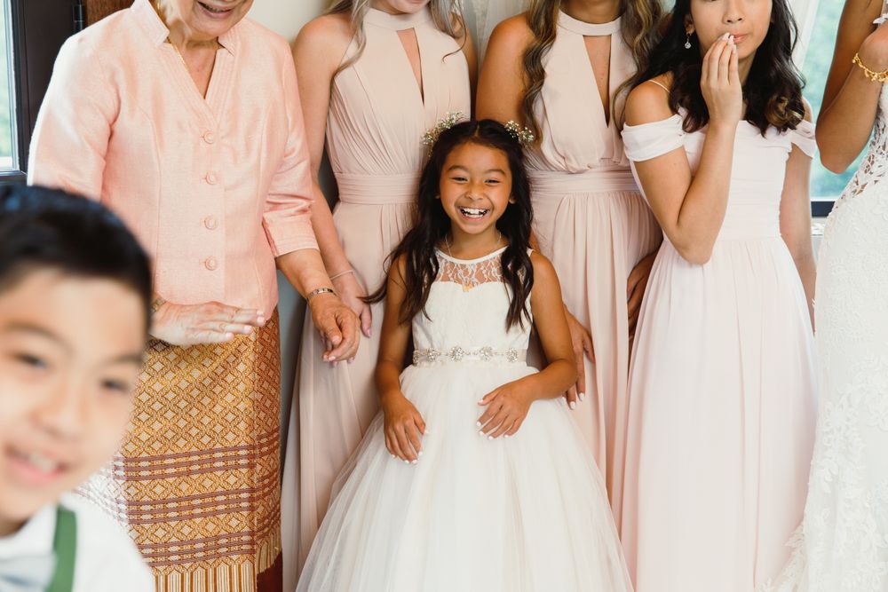 Wedding party members in coordinated pink and white attire.