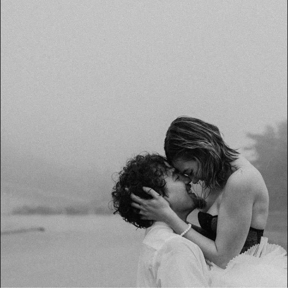 moody black and white elopement photos of a couple in the rain and fog